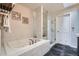 Bright bathroom with a soaking tub, glass-enclosed shower, and modern fixtures at 222 S Monroe St, Denver, CO 80209