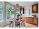 Charming breakfast nook with a round table, three stools, and natural light from a large window at 222 S Monroe St, Denver, CO 80209