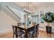 Dining area with hardwood floors and modern lighting fixture with views to the staircase and living room at 222 S Monroe St, Denver, CO 80209