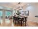 Spacious dining room with hardwood floors, views to the living room, and a modern chandelier at 222 S Monroe St, Denver, CO 80209