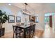 Elegant dining room featuring a modern chandelier and an open view into the kitchen at 222 S Monroe St, Denver, CO 80209