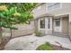 Exterior view of home's entrance and private patio area shaded by a flowering tree at 222 S Monroe St, Denver, CO 80209