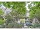 Exterior shot of home with lush landscaping, brick accents, and large windows for natural light at 222 S Monroe St, Denver, CO 80209