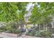 Landscaped front yard with view of the home's brick and siding exterior and multi-paned windows at 222 S Monroe St, Denver, CO 80209