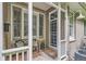 Charming front porch with brick facade, bench seating, and decorative front door at 222 S Monroe St, Denver, CO 80209