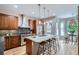 Modern kitchen featuring stainless steel appliances, a center island with seating, and ample cabinet space at 222 S Monroe St, Denver, CO 80209