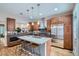 Gourmet kitchen with stainless steel appliances, a large island with seating, and hardwood floors at 222 S Monroe St, Denver, CO 80209