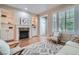Bright living room featuring hardwood floors, a fireplace with built-ins, and plantation shutters at 222 S Monroe St, Denver, CO 80209