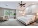 Serene main bedroom featuring a plush bed, sitting area, and ample natural light at 222 S Monroe St, Denver, CO 80209