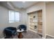 Relaxing sitting area featuring a window, comfortable chairs, and an open built-in bookshelf display at 222 S Monroe St, Denver, CO 80209