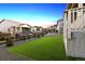 Well-maintained backyard features artificial turf, a black fence, and well manicured landscaping at 22046 E Allenspark Pl, Aurora, CO 80016