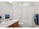 Clean bathroom with shower and bath featuring tiled walls and a stylish vanity at 22046 E Allenspark Pl, Aurora, CO 80016