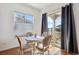 Cozy dining area featuring a round table, four chairs, slider to outdoor patio and lots of natural light at 22046 E Allenspark Pl, Aurora, CO 80016