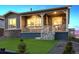 Cozy home featuring a covered porch and stone details and a green artificial lawn at 22046 E Allenspark Pl, Aurora, CO 80016