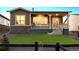 Attractive home showcasing a covered porch and stone elements with a well maintained artificial lawn at 22046 E Allenspark Pl, Aurora, CO 80016