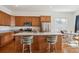 Beautiful kitchen with stainless steel appliances, an island with bar stools, and hardwood floors at 22046 E Allenspark Pl, Aurora, CO 80016