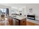Spacious kitchen with granite island flowing into a living area with fireplace at 22046 E Allenspark Pl, Aurora, CO 80016