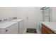 Functional laundry room with modern washer and dryer and storage space at 22046 E Allenspark Pl, Aurora, CO 80016