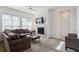 Cozy living room with a fireplace, large windows, and comfortable seating at 22046 E Allenspark Pl, Aurora, CO 80016