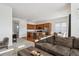 Open-concept living and dining area, with hardwood floors, stainless steel appliances, and breakfast bar seating at 22046 E Allenspark Pl, Aurora, CO 80016