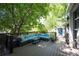 Inviting outdoor living space with comfortable seating shaded by mature trees at 2957 Osceola St, Denver, CO 80212