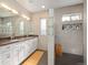 Modern bathroom featuring dual sinks, granite countertops, and a stylish walk-in shower with decorative tiles at 2957 Osceola St, Denver, CO 80212