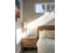 Cozy bedroom with natural light, hardwood floors and nightstand with lamp at 2957 Osceola St, Denver, CO 80212