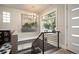 Bright hallway with modern lighting, stylish railing, and views of lush greenery through a large window at 2957 Osceola St, Denver, CO 80212