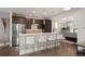 Modern kitchen features stainless steel appliances, white countertop seating area, and dark cabinetry at 2957 Osceola St, Denver, CO 80212