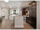 Modern open kitchen with bar seating, stainless steel appliances, and stylish decor flowing into the living area at 2957 Osceola St, Denver, CO 80212