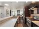 Modern open kitchen with long countertop and stainless steel appliances overlooks living area at 2957 Osceola St, Denver, CO 80212
