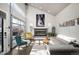 Bright living room featuring high ceilings, fireplace, and modern decor with floor-to-ceiling windows at 2957 Osceola St, Denver, CO 80212