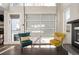 Cozy living room featuring hardwood floors, two accent chairs and an industrial style glass door at 2957 Osceola St, Denver, CO 80212