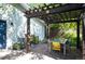 Outdoor dining area with grill under a pergola, next to a white home at 2957 Osceola St, Denver, CO 80212