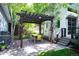 Outdoor dining area under a pergola, complete with a grill and seating at 2957 Osceola St, Denver, CO 80212