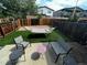 Cozy backyard oasis featuring a hammock, outdoor seating, and lush artificial turf at 5316 Stuart St, Denver, CO 80212