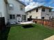 A well-maintained backyard with synthetic grass, a hammock, and a patio area at 5316 Stuart St, Denver, CO 80212