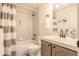 Cozy bathroom with a shower-tub combo, tile surround, large mirror, and a modern vanity at 5316 Stuart St, Denver, CO 80212