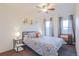 Inviting bedroom with large windows, side tables, lamps, and art prints above the headboard at 5316 Stuart St, Denver, CO 80212