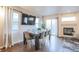 Bright dining room with a modern table set for eight, a fireplace, and sliding glass doors to the backyard at 5316 Stuart St, Denver, CO 80212