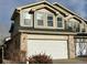 Two-story home featuring a two-car garage with brick accents at 5316 Stuart St, Denver, CO 80212