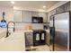 Well-equipped kitchen with modern appliances, gray cabinets, and ample counter space at 5316 Stuart St, Denver, CO 80212