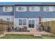 Well-maintained backyard with a patio, artificial grass, and contemporary patio furniture great for relaxing or entertaining at 11009 Gaylord St, Northglenn, CO 80233