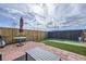 Landscaped backyard with artificial grass, a patio, and outdoor dining table perfect for entertaining and relaxation at 11009 Gaylord St, Northglenn, CO 80233