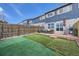 Spacious backyard featuring a patio, artificial grass and modern patio furniture for a relaxing outdoor space at 11009 Gaylord St, Northglenn, CO 80233