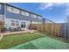Fenced backyard with patio, artificial grass and modern patio furniture creating a perfect outdoor living space at 11009 Gaylord St, Northglenn, CO 80233