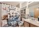 Quirky bathroom features a fun shower curtain and toilet seat cover adding personality to the space at 11009 Gaylord St, Northglenn, CO 80233