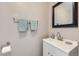 Cozy half bathroom with a modern vanity, stylish mirror, and decorative towels at 11009 Gaylord St, Northglenn, CO 80233