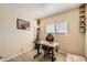 Bright bedroom features an ergonomic office chair, desk, and shelves near the window for a comfortable workspace at 11009 Gaylord St, Northglenn, CO 80233