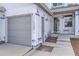 Exterior in progress featuring a gray garage door, landscaping, and front door at 11009 Gaylord St, Northglenn, CO 80233